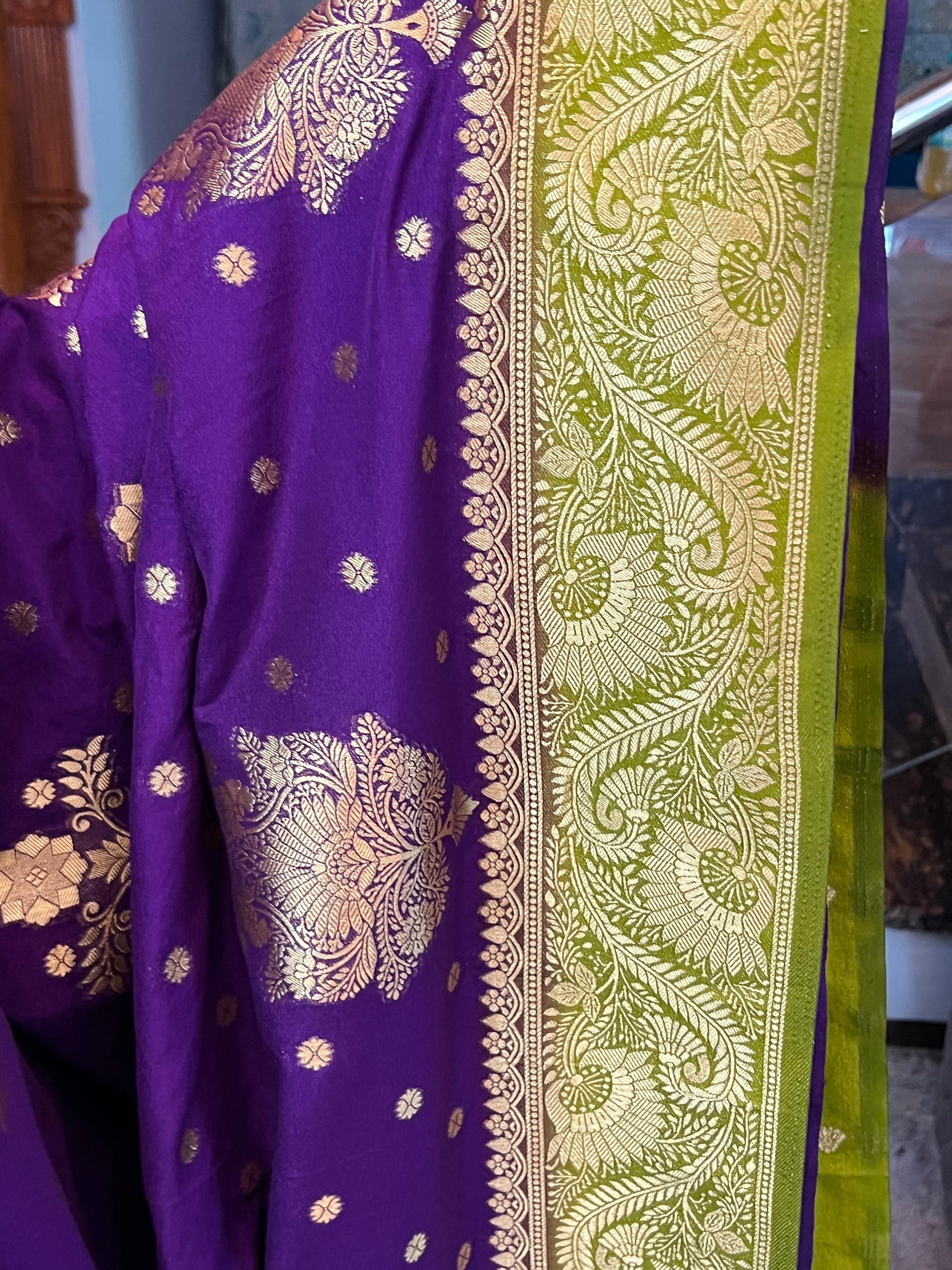 Purple fabric with gold embroidery and green border