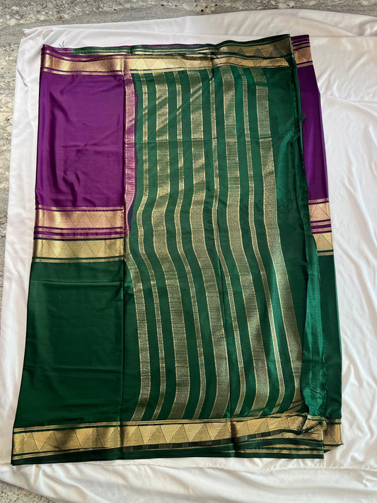 Green and purple saree with gold stripes on a white background